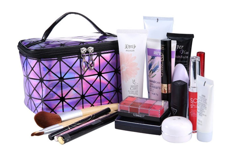 Purple holographic cosmetic bag with assorted makeup items arranged beside it