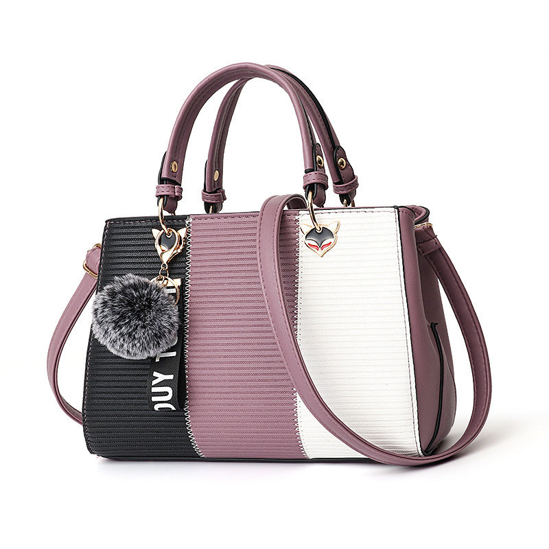 Color-block PU leather handbag with top handles and crossbody strap; mauve, black and white panels