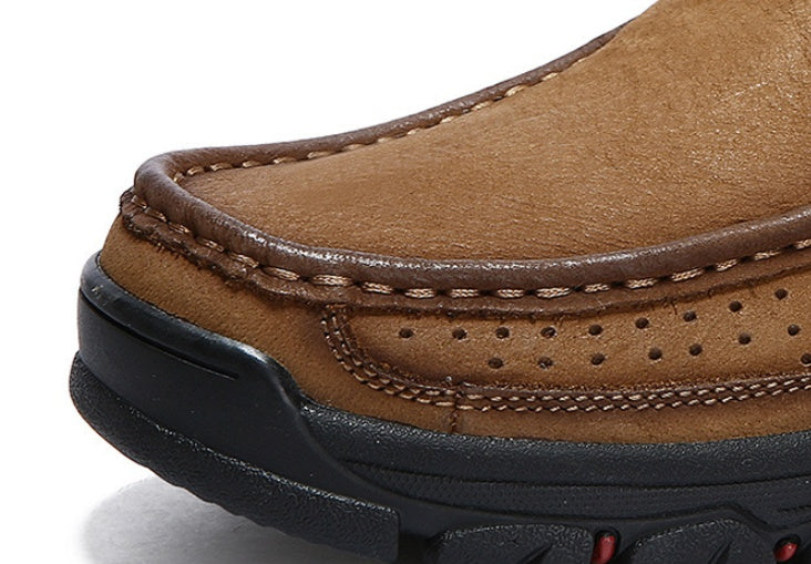 Close-up of a brown leather shoe with black sole on a white background