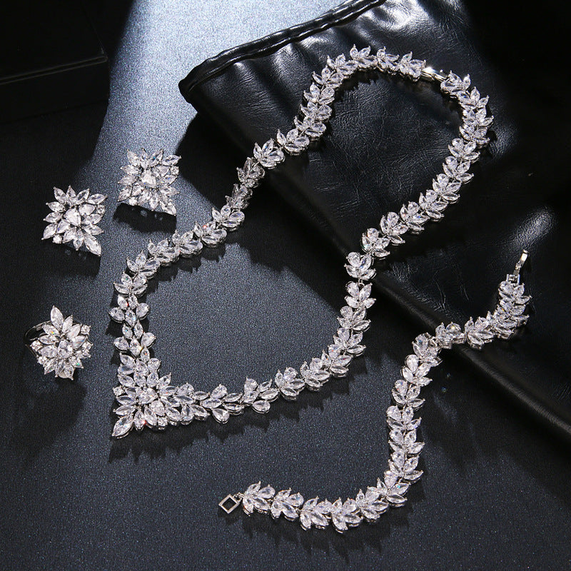 Silver zircon floral necklace with matching bracelet and earrings, plus a statement ring