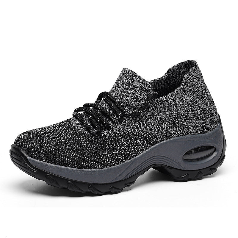 Gray knit lace-up athletic shoes with dark sole and oval air window detail