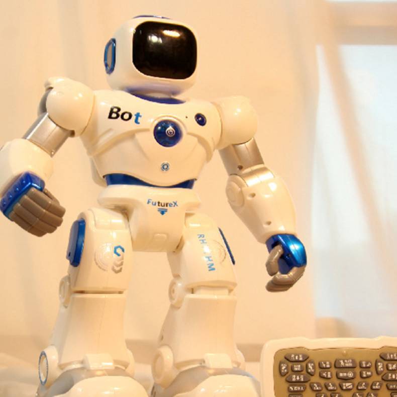 Cream robot toy with blue-lit head screen and remote keyboard controller
