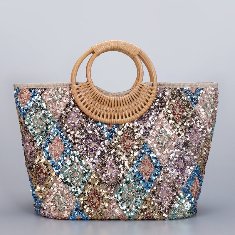 Large woven cotton tote bag with all-over sequin pattern and woven rattan top handle, multicolor