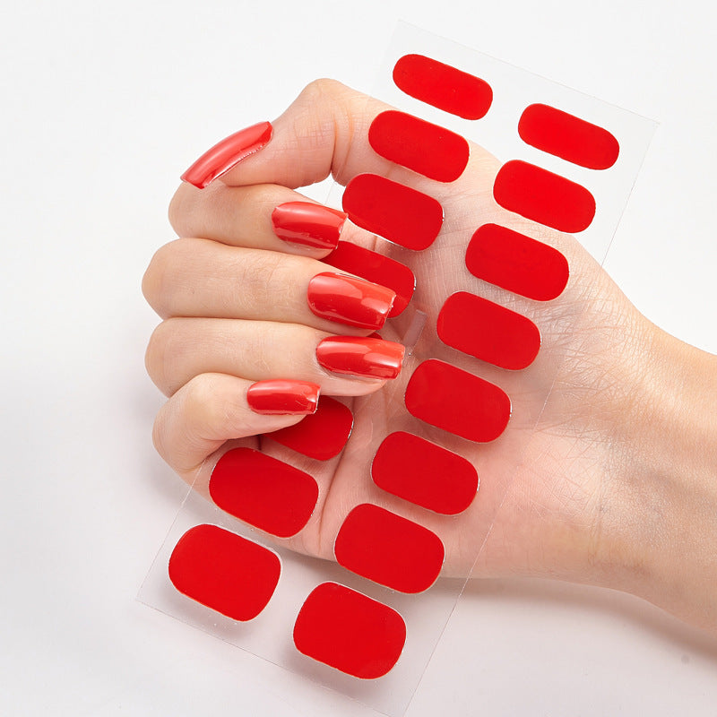 Nail sticker wraps on clear sheet with bright red solid nail decals