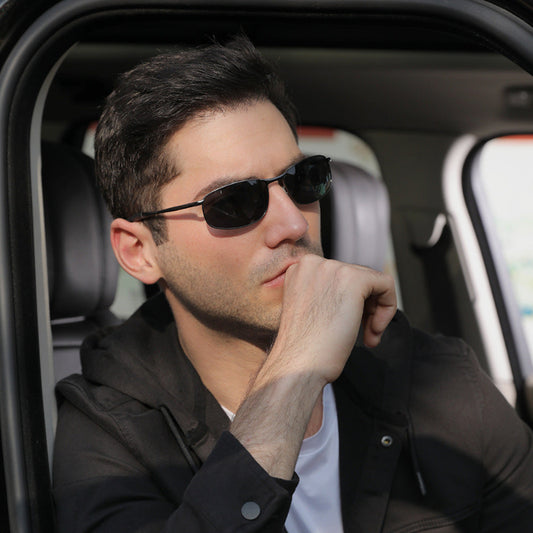 Man wearing sunglasses sitting inside a car