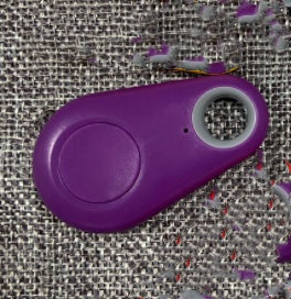 Purple electronic device with a button on a textured gray background