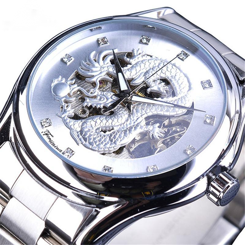 Silver wristwatch with dragon design on the face against a white background