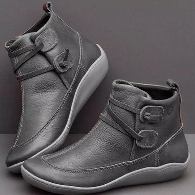 Pair of gray ankle boots on a gray background