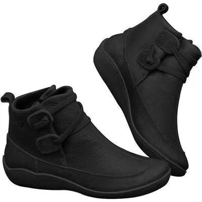 Pair of black ankle boots with bow details on a white background
