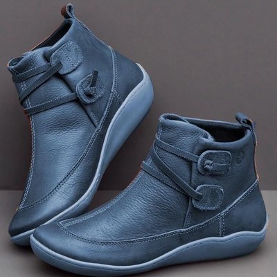 Pair of blue ankle boots on a gray background