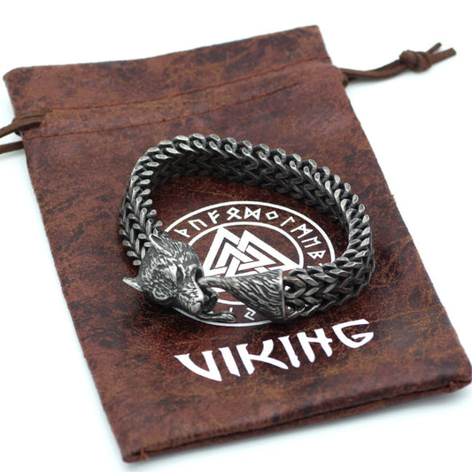 Silver bracelet with wolf design on a brown drawstring bag with 'Viking' branding.