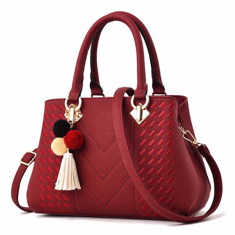 Women's crossbody handbag, wine red PU leather with pom tassel charm and gold-tone hardware
