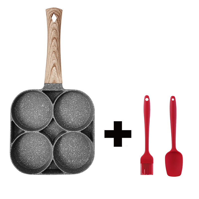 Frying pan with wooden handle and four round compartments, plus two red silicone utensils on a white background.