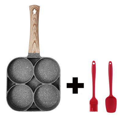Frying pan with wooden handle and four round compartments, plus two red silicone utensils on a white background.