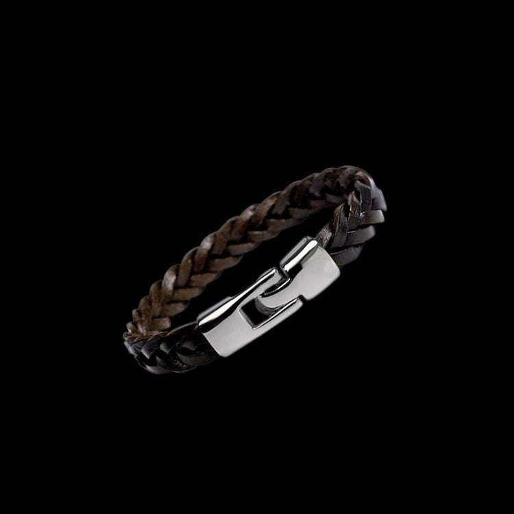 Brown braided leather bracelet close-up with silver-tone rectangular buckle clasp.