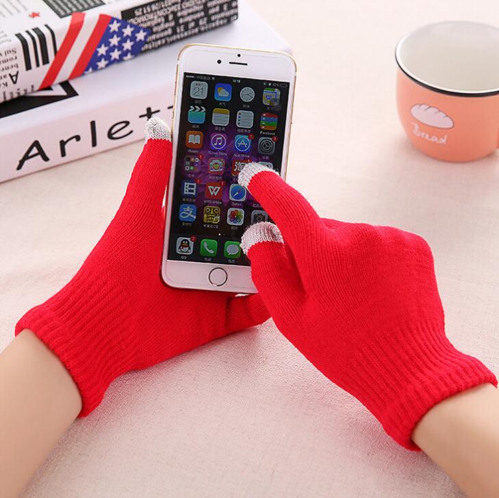 Red touchscreen knit gloves with ribbed cuffs, hands using smartphone
