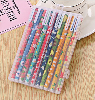 Set of colorful pens in a transparent case on a wooden surface
