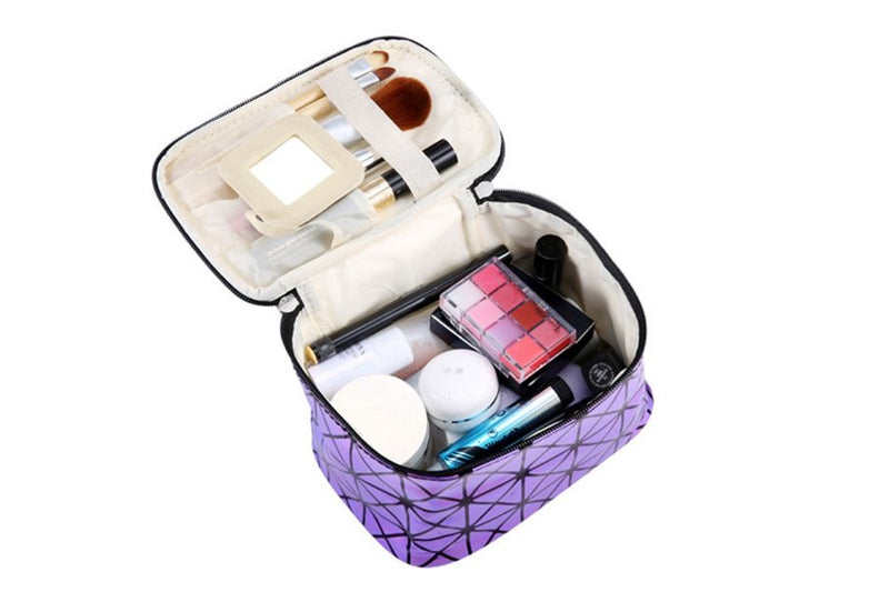 Holographic cosmetic bag open, purple geometric design with makeup items inside