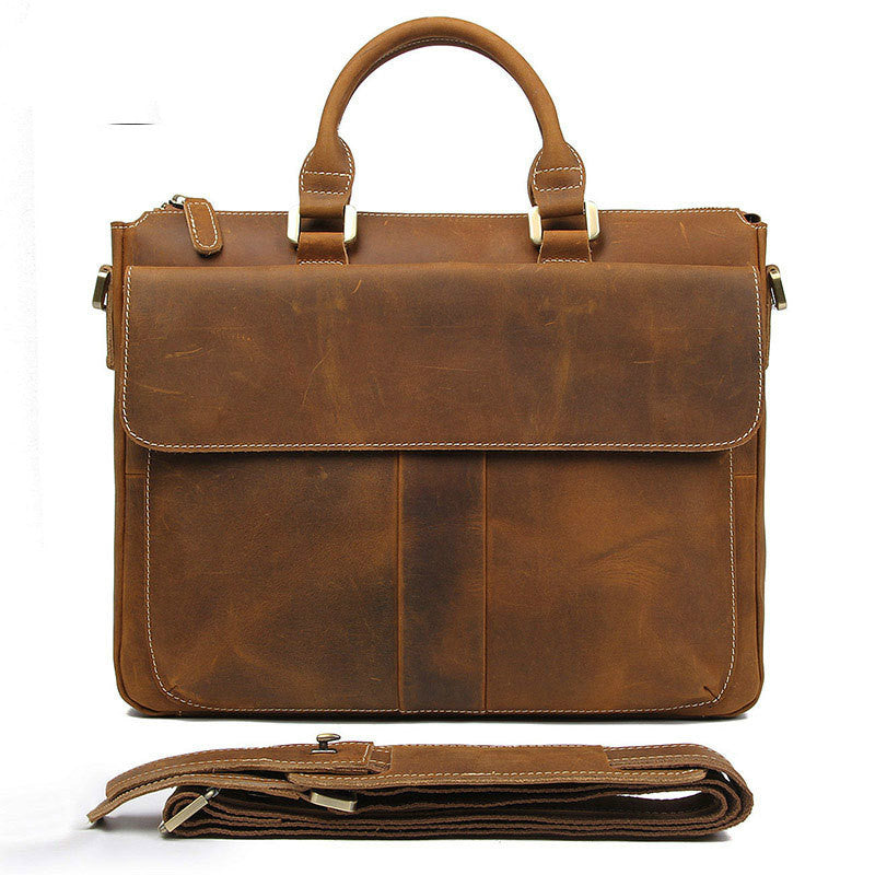 Light brown leather crossbody bag with front flap, top handles, and shoulder strap.