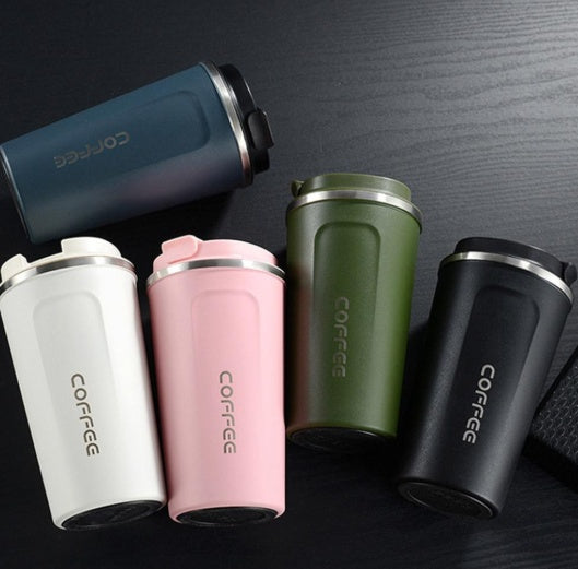 Five colorful coffee tumblers with 'COFFEE' text on a dark surface