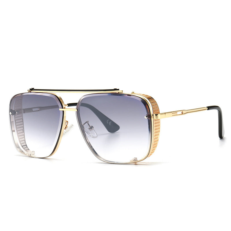 Oversized square sunglasses with deep blue lenses and gold-tone frame