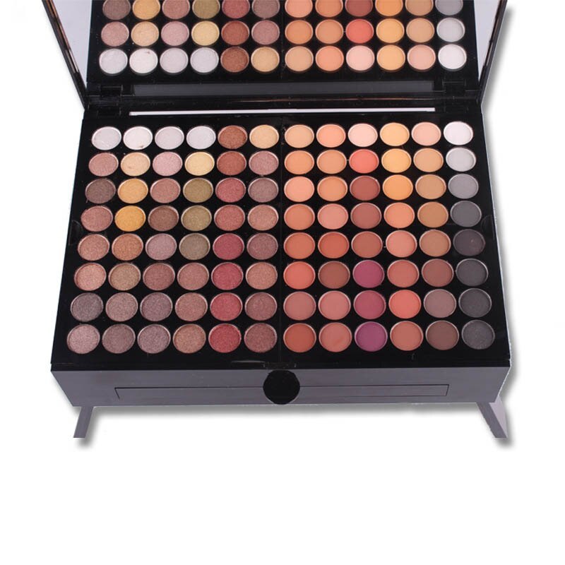 Open palette with rows of neutral and warm eyeshadow shades in a black case