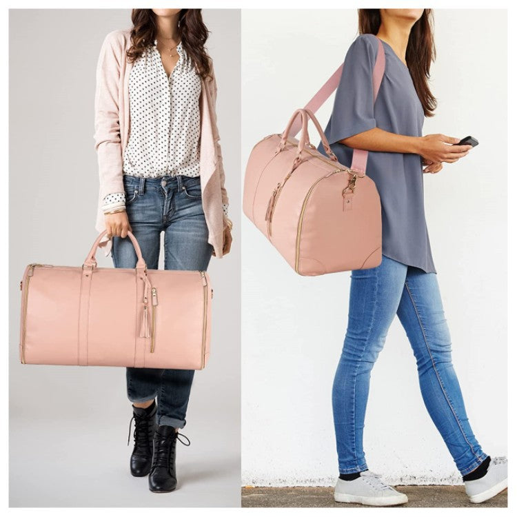 Pink large-capacity travel duffel bag on a person, held by top handles with shoulder strap