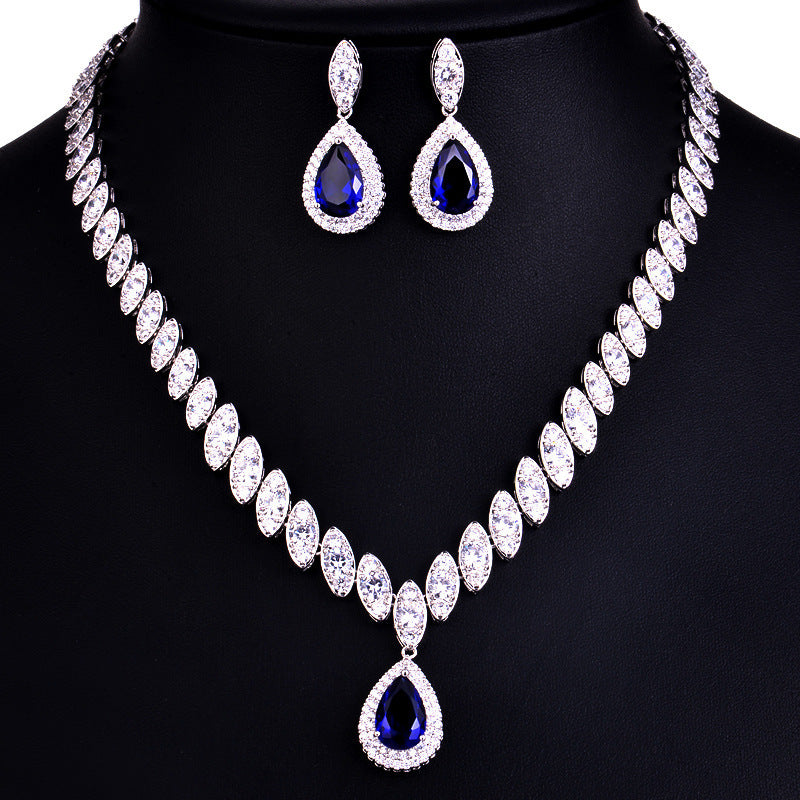 Jewelry set with necklace and earrings on a black stand
