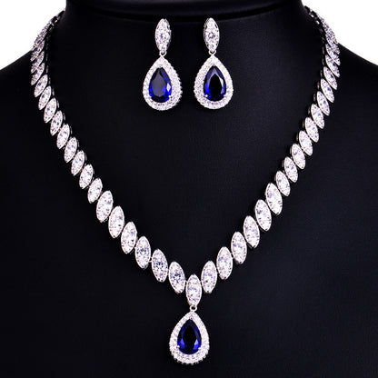 Jewelry set with necklace and earrings on a black stand