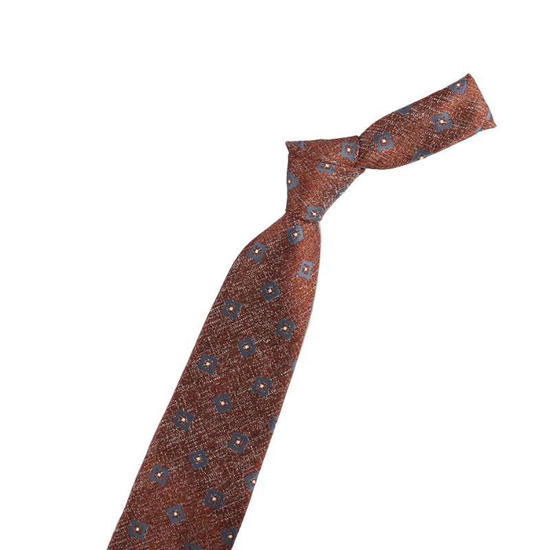 Brown patterned tie with a violin-shaped object on a white background