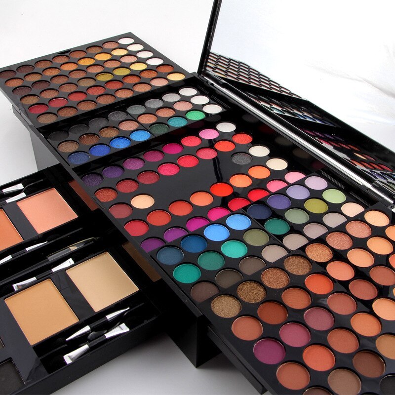 Open 180-color eyeshadow palette with bright multicolor pans, blush squares, and applicators