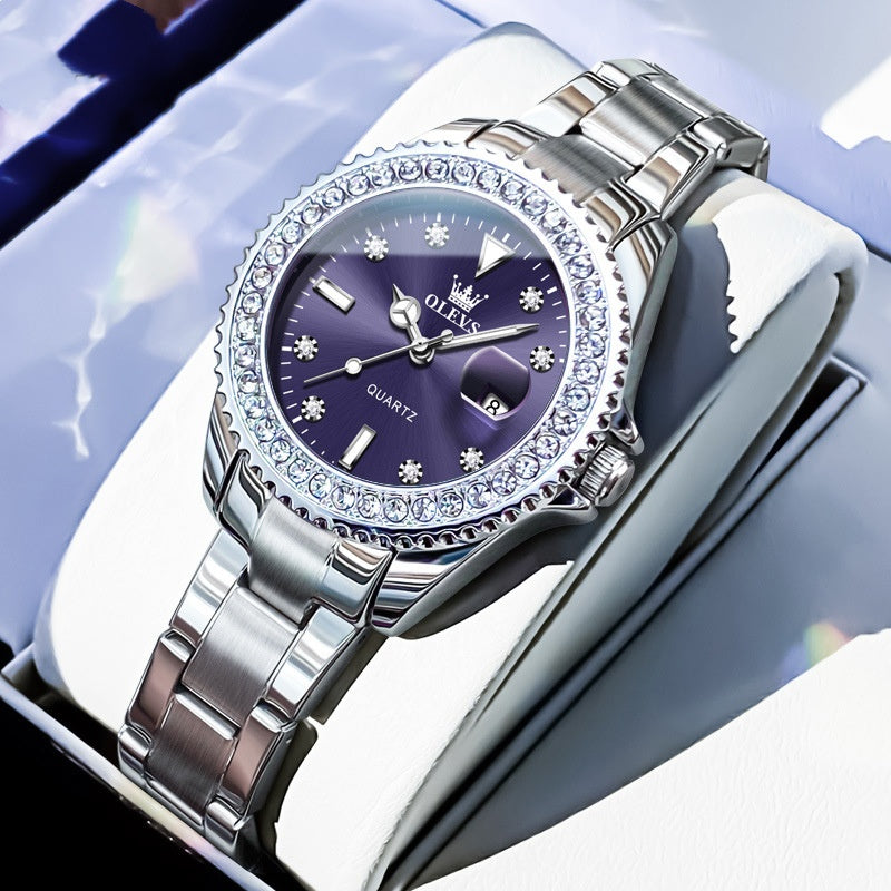 Quartz wristwatch with dark blue dial, crystal bezel, and silver metal link bracelet