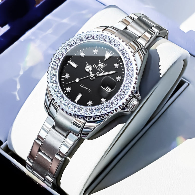 Quartz wristwatch with dark dial, crystal bezel, and silver metal link bracelet
