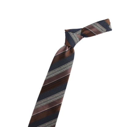 Striped tie with a gold violin-shaped accessory on a white background