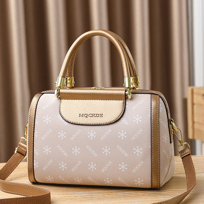 Designer handbag with gold accents on a wooden surface