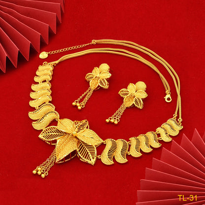 Gold necklace and earrings on a red background