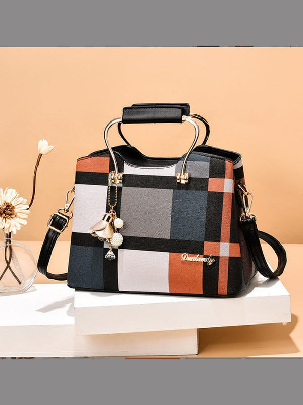 Plaid handbag with top handle and black crossbody strap, gold-tone hardware and keychain charm