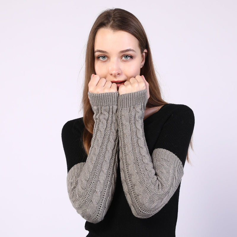 Twist-knit fingerless arm warmers in dark grey, long sleeves with textured cable knit