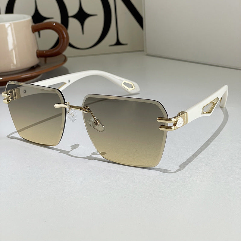 Square sunglasses with warm gradient lenses, light frame, gold-tone geometric side plates