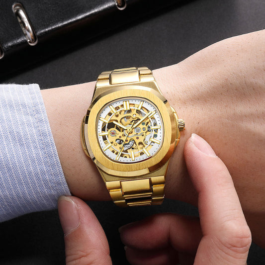 Gold wristwatch with a mechanical design on a person's wrist.