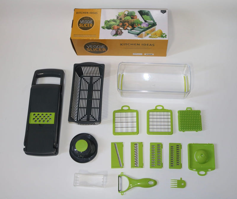 Kitchen vegetable slicer kit with green and black cutting plates and tool parts