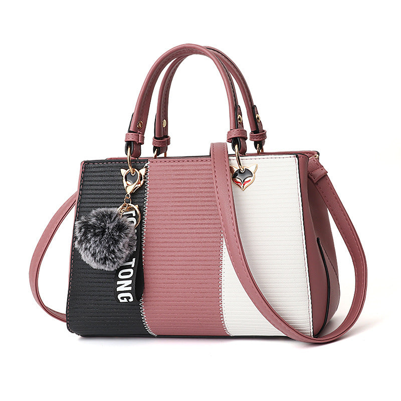 Color-block PU leather handbag with top handles, crossbody strap; pink, black and white panels