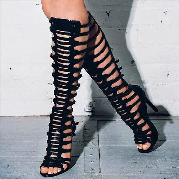 Black knee-high gladiator stiletto sandals with crisscross straps and stiletto heel