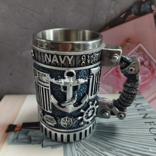 Navy-themed mug with anchor design on a surface