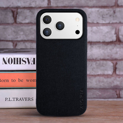 Black phone case with 'Nillkin' branding on a wooden surface with books in the background.