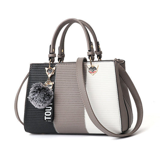 Multicolored handbag with decorative elements on a white background