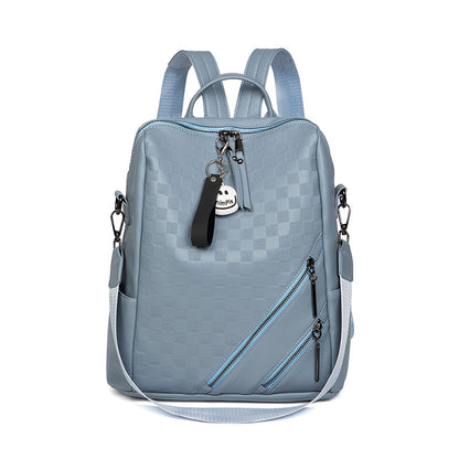 Light blue backpack with a keychain on a white background