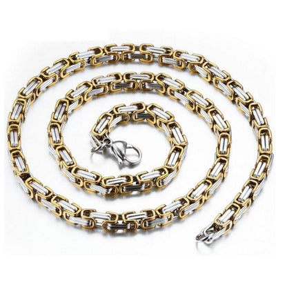 Gold and silver chain necklace on a white background