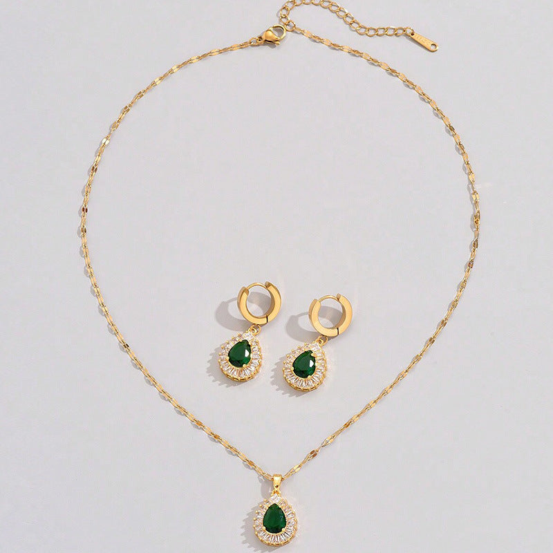 Gold-tone necklace with matching green teardrop drop earrings and crystal halos