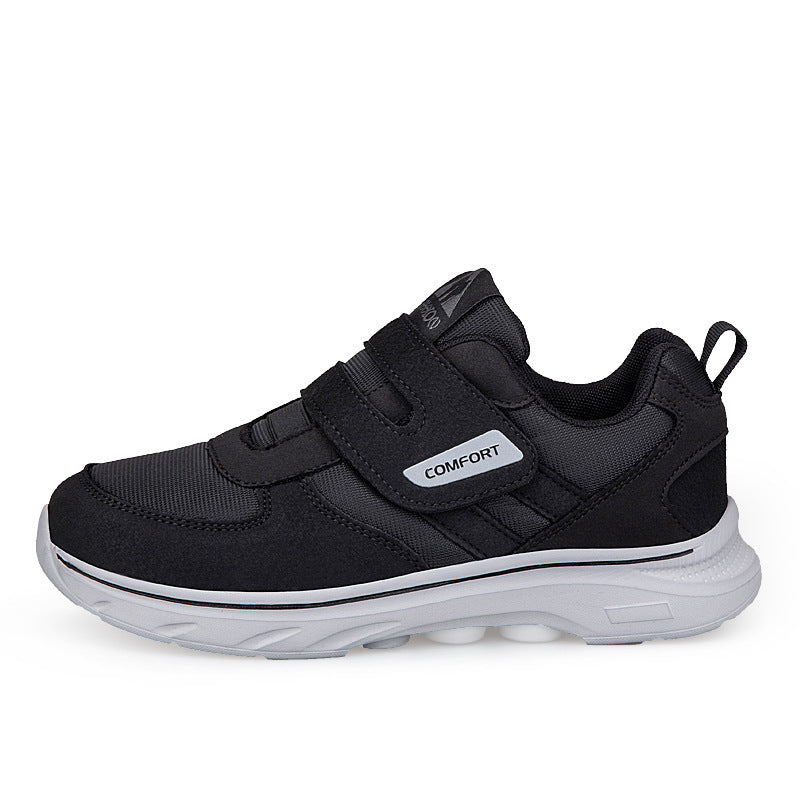 Black lightweight casual sneakers with hook-and-loop closure and white midsole